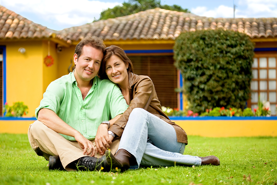 Happy Couple Outside Their Home